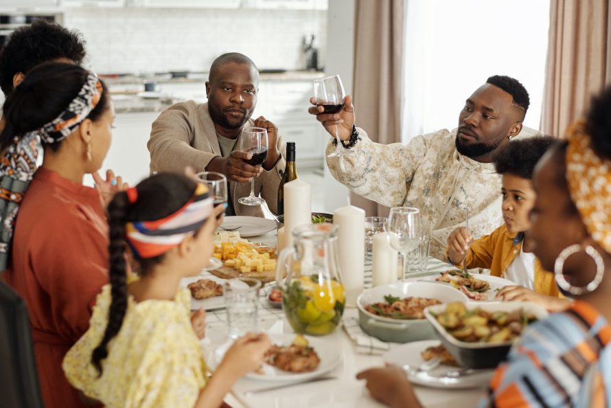 Family toasting and having dinner to celebrate combining two households